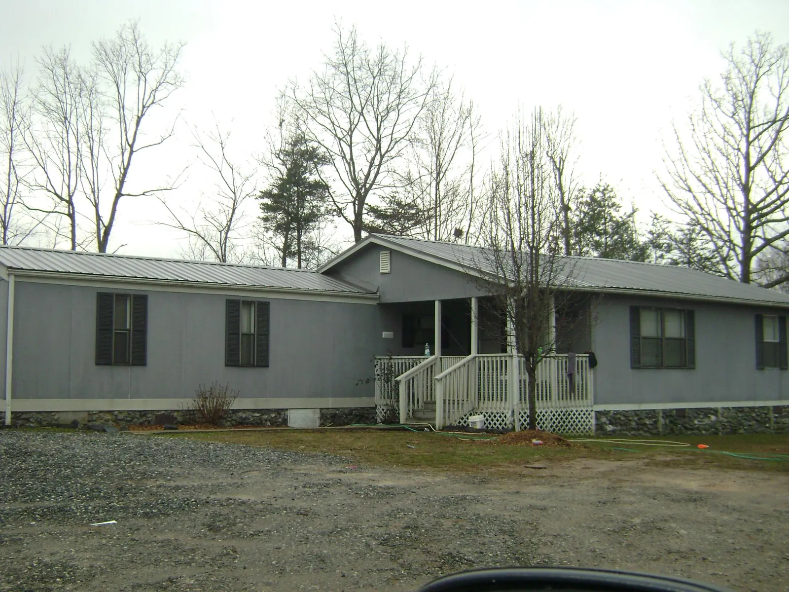 Metal roof over a manufactured home with a covered front porch in Auburn